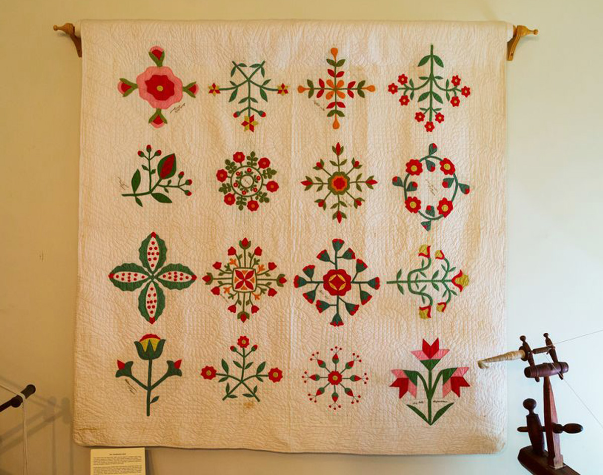 Antique quilt displayed on wall